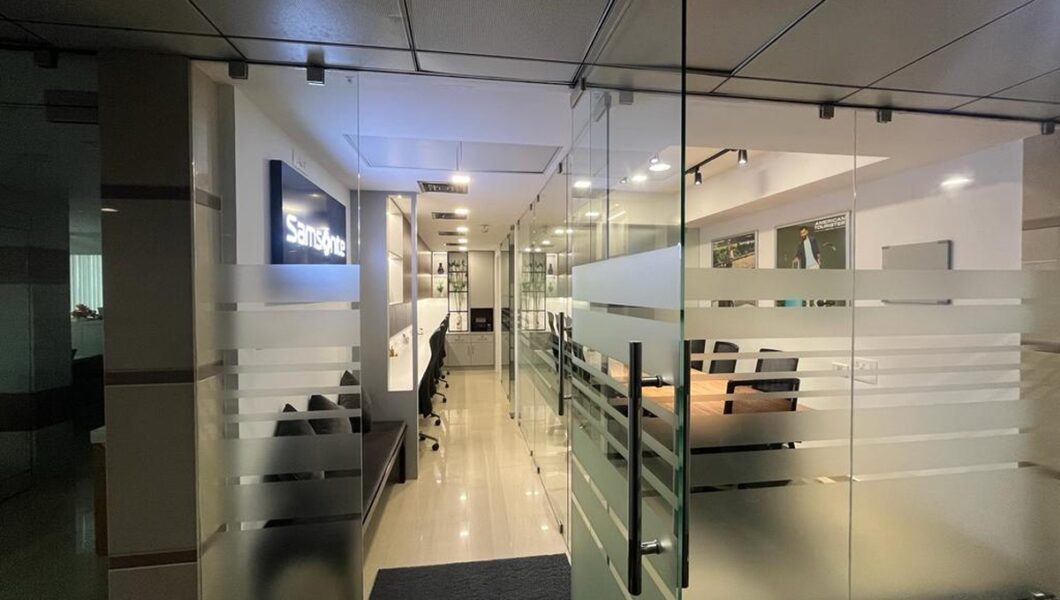 Modern Samsonite office interior with glass partitions, clean lines, and a professional corporate workspace design.